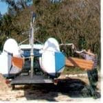 Larry Tibbe, below, scampers around Stiletto's hull as he casts off tic-downs before beginning the setting-up process. Note boat's narrow beam for trailering